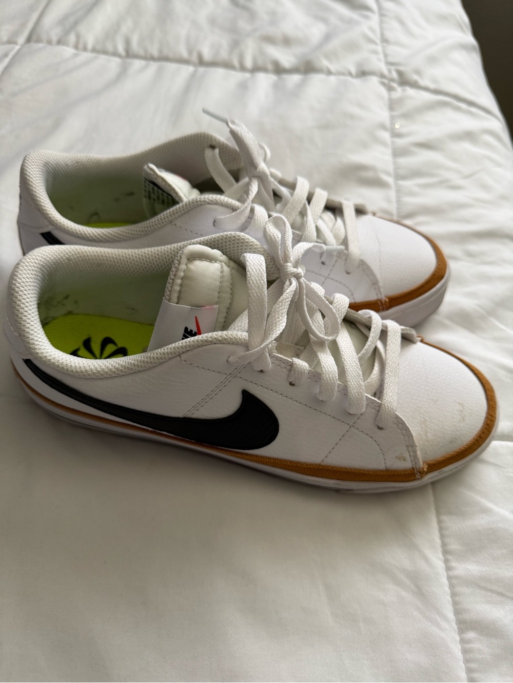 Nike White Low-Top Sneakers with Black Swoosh and Brown Trim